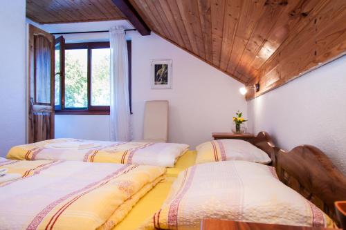 a group of four beds in a room at B&B Villa Nena in Plitvica Selo