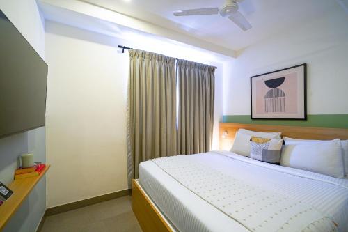 Ένα ή περισσότερα κρεβάτια σε δωμάτιο στο Olive Hotel JP Nagar by Embassy Group