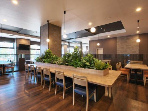 a dining room with a large table and chairs at Hotel Route Inn Grand Moriya Ekimae in Moriya