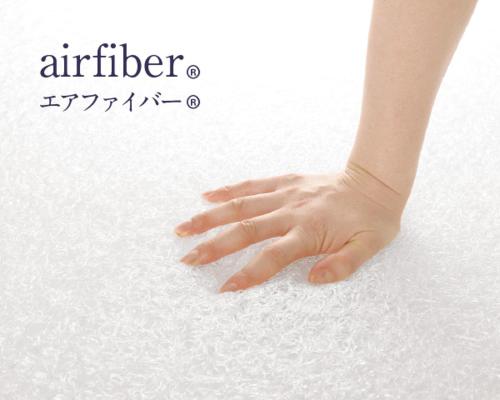 a woman with her hand on a white towel at Torifito Hotel & Pod Kanazawa in Kanazawa