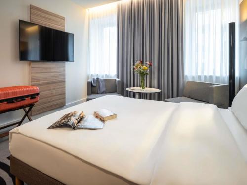 Ένα ή περισσότερα κρεβάτια σε δωμάτιο στο Novotel Wien City