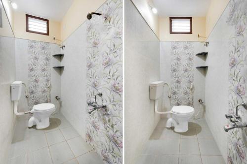 a bathroom with two toilets and flowers on the wall at Hotel O Tirumala Hill View in Chandragiri