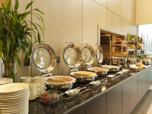 a buffet line with many pots and pans of food at ibis Sharq in Kuwait