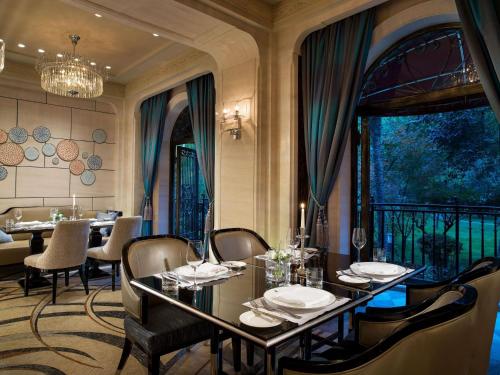 a dining room with a table and chairs and a balcony at Sofitel Legend People's Grand Hotel Xi'an in Xi'an