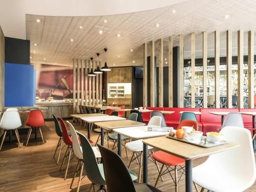 a restaurant with tables and chairs and a bar at ibis Bordeaux Centre Bastide in Bordeaux