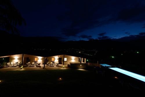 a house at night with a swimming pool and lights at Moar Lodge in Postal