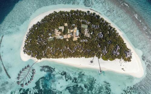 an island in the middle of a body of water at Coco Palm Dhuni Kolhu in Thulhaadhoo