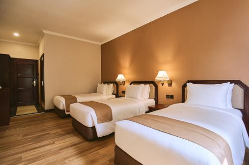 Postel nebo postele na pokoji v ubytování Horison Resort Tulip Puncak