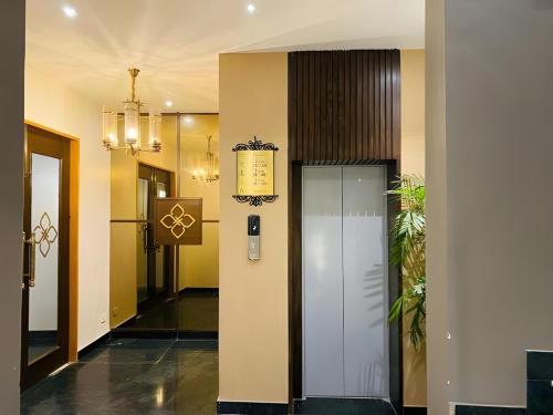 a hallway of a building with a elevator at Hotel Imperial Park in Gurgaon
