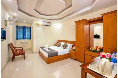 a bedroom with a bed and a desk in a room at Vembanad Village Backwater Resort by EGH in Alleppey