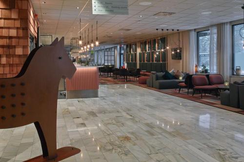 a lobby with a wooden horse on the floor at Scandic Borlänge in Borlänge