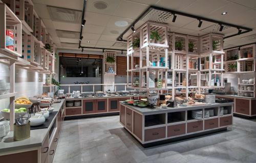 a large kitchen with a lot of food at Scandic Borlänge in Borlänge