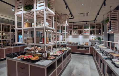 a large kitchen with a lot of food on display at Scandic Borlänge in Borlänge