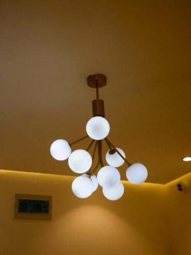 a chandelier hanging from a ceiling in a room at Luxury & Modern Self Check-In Apts near Airport M02b in Lagos