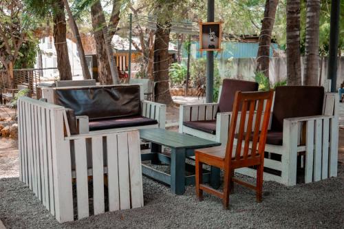 a group of chairs and a table and a fence at Hotel & Apartment Serene in Dar es Salaam