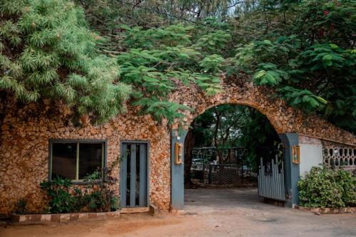 an entrance to a stone building with an archway at Hotel & Apartment Serene in Dar es Salaam