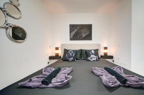 a bedroom with a bed with purple blankets at D Top View in St. Paul's Bay