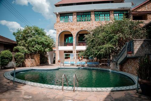 a swimming pool in front of a building at Hotel & Apartment Serene in Dar es Salaam