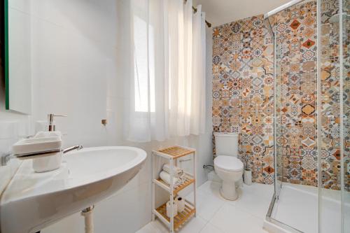 a bathroom with a sink and a toilet and a shower at D Top View in St. Paul's Bay