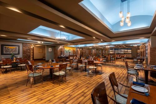 a restaurant with wooden floors and tables and chairs at Radisson Blu Hotel Pune Kharadi in Pune