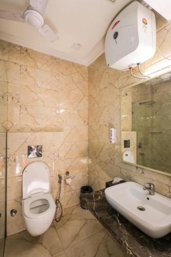 a bathroom with a toilet and a sink at Nikko Blue - Boutique Hotel in Gurgaon