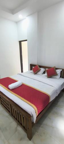 a large bed in a room with avertisement for at Blue Home Stay in Kanthalloor