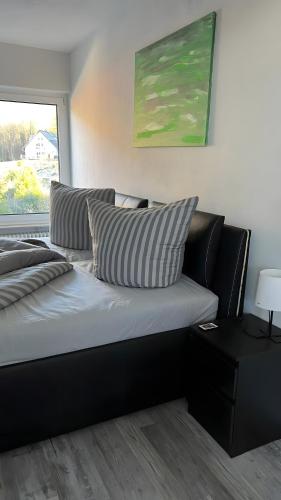 a bed with two pillows on it in a room at Fewo Fischer am Bischenberg in Sasbachwalden