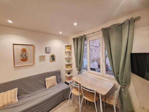 a living room with a couch and a table at Casa Pastel in Mèze