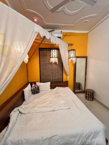 a bedroom with a large bed with a canopy at CASA BOHEMIAn in Rishīkesh
