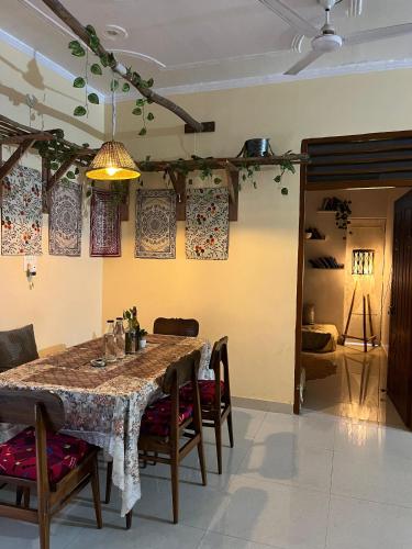 a dining room with a large table and chairs at CASA BOHEMIAn in Rishīkesh