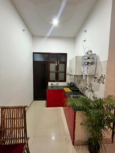 a kitchen with a sink and a red cabinet at CASA BOHEMIAn in Rishīkesh