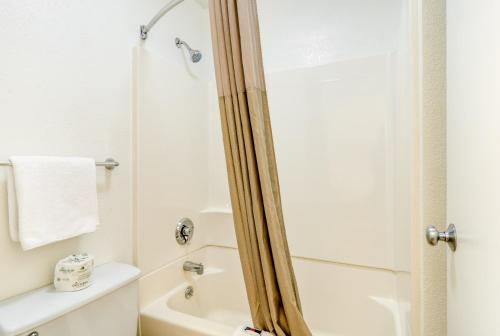 a bathroom with a shower and a toilet and a sink at Motel 6-Schiller Park, IL - Chicago O'Hare in Rosemont