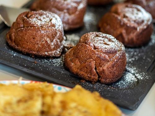 a tray of donuts with powdered sugar on them at ibis Styles Strasbourg Stade de la Meinau in Strasbourg