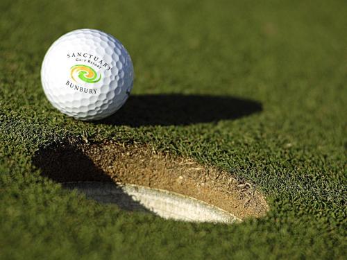 a white golf ball sitting on a putting green at Mercure Bunbury Sanctuary Golf Resort in Bunbury