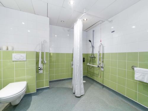 a bathroom with a toilet and a shower in it at ibis budget Southampton Centre in Southampton