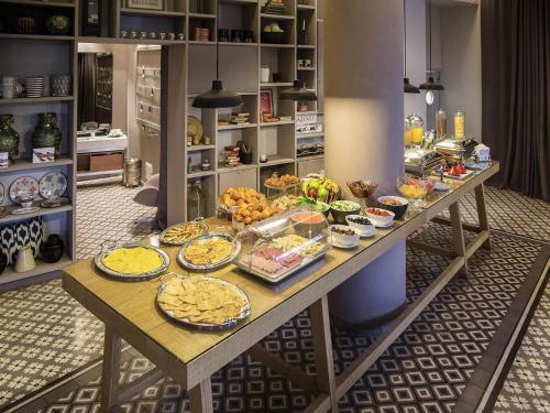 a table with a bunch of food on it at Novotel Marrakech Hivernage in Marrakech