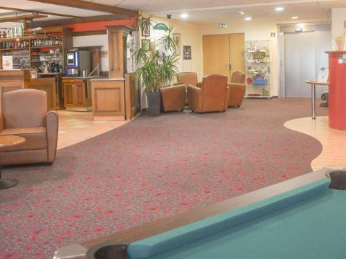 a waiting room with chairs and a pool at ibis Albert Pays de Somme in Albert