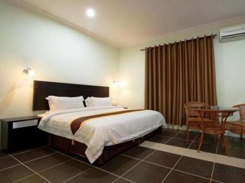 Postel nebo postele na pokoji v ubytování Han Palace Hotel Semporna