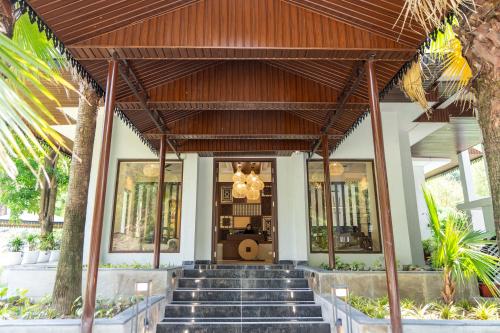 a lobby of a building with stairs in front at Aranyam in Rishīkesh