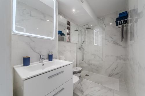 a white bathroom with a sink and a shower at Costa Dreams Costa Adeje in Costa de Adeje