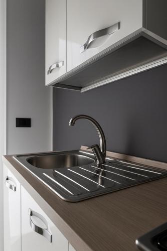a stainless steel sink in a kitchen at Beautiful floral apartment on Navigli in Milan