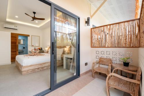 a bedroom with a bed and a room with a table at Eden Extend Fisherman's village in Koh Samui 