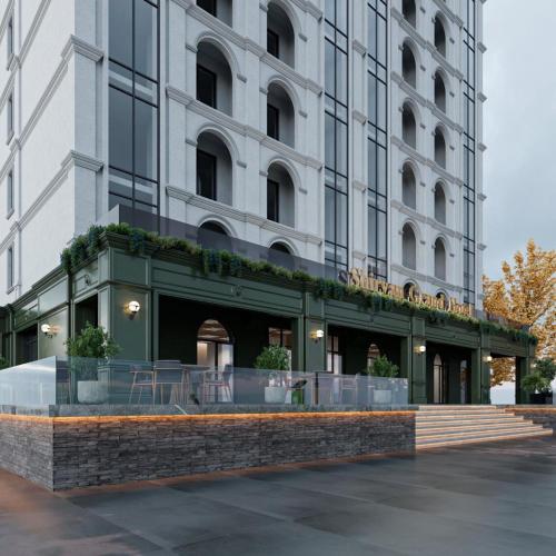a building with a cafe in front of it at Shirvan Grand Hotel Shamakhi in Şamaxı