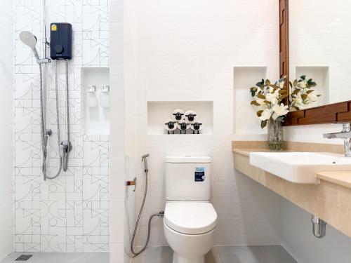 a bathroom with a toilet and a sink and a shower at Uncle J House in Phuket