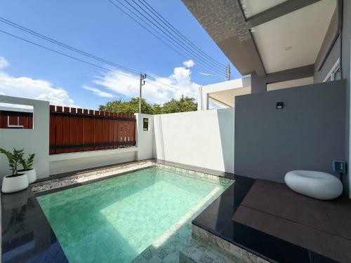 a swimming pool in the backyard of a house at Uncle J House in Phuket