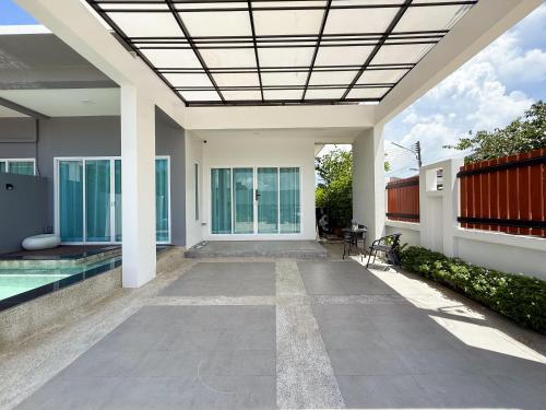 a house with a swimming pool and a ceiling at Uncle J House in Phuket