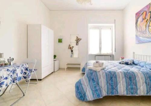 a bedroom with a bed and a table in it at Il Soffione Home in Salerno