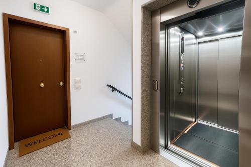 a elevator in a building with a welcome sign next to a door at Civico 44 in Ravenna