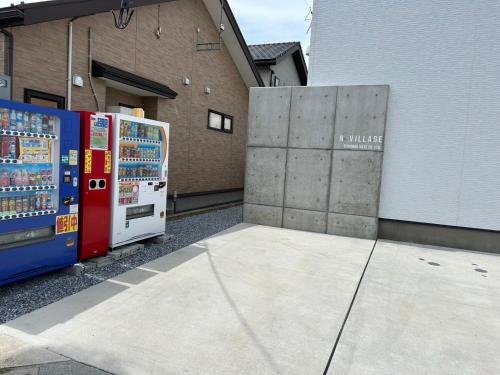 two vending machines are parked outside of a building at 八戸駅西口民泊ゲストルームNvillage in Hachinohe