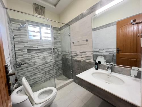 a bathroom with a toilet and a sink and a shower at Luxury Holiday Home Margala Hills Views Islamabad in Islamabad